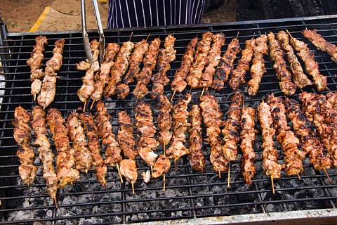 Barbecueing chicken skewers at the Notting Hill Carnival London
