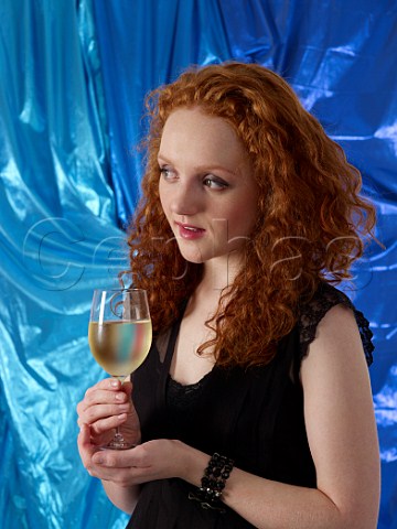 Young woman holding a glass of white wine