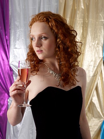 Young woman holding a glass of ros champagne