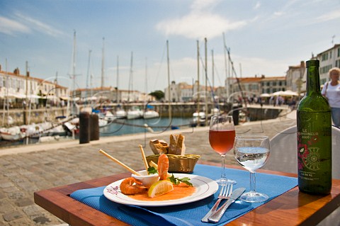 Seafood starter and ros wine at harbour front restaurant StMartindeR Ile de R CharenteMaritime France PoitouCharentes