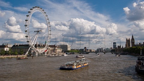 Pleasure boat on the River Thames passing the London Eye
