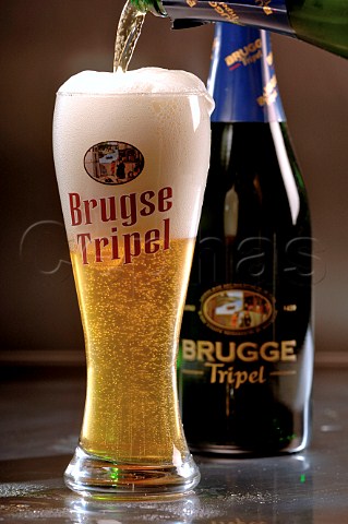 Pouring glass of Brugse Tripel Belgian beer