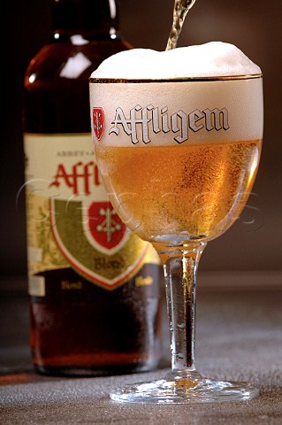 Pouring glass of Affligem Belgian beer