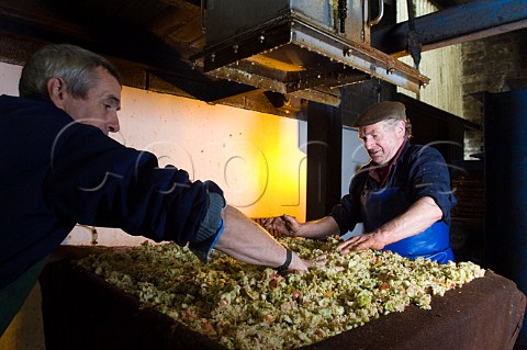 Artisan cider maker Roger Wilkins building a cheese of crushed apples for pressing on his hydraulic Beare press  Wilkins Cider Landsend Farm Mudgley Wedmore Somerset England