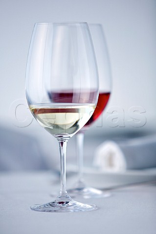Glasses of red and white wines on a white tablecloth