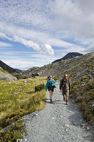 Couple on Hooker Valley trail Mt Cook  Aoraki National Park South Island New Zealand