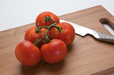 Organic vine tomatoes on cutting board