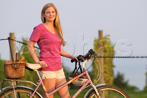 Woman with bicycle in vineyard
