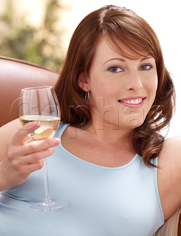 Young woman drinking glass of white wine
