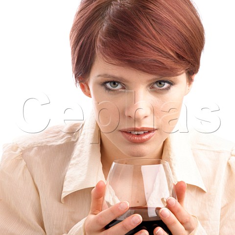 Young woman holding glass of red wine