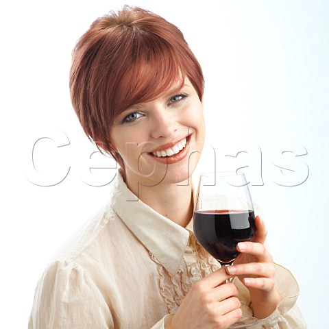 Young woman holding glass of red wine