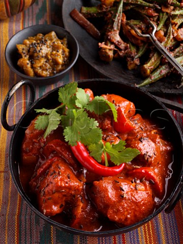 Chicken vindaloo Indian hot curry with okra and aubergine chutney