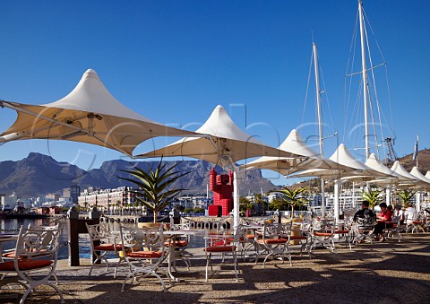 Hotel terrace on the VA Waterfront with the Coca Cola crateman and Table Mountain beyond Cape Town Western Cape South Africa