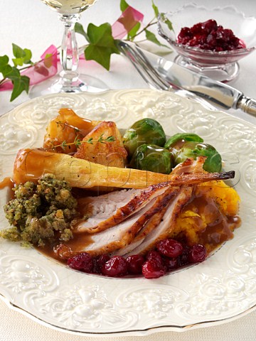 Turkey slices with roast potatoes parsnips herb stuffing Brussels Sprouts cranberries sweet potato mash gravy