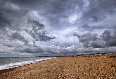 Stormy sky over the shingle beach at ShorehambySea Sussex England