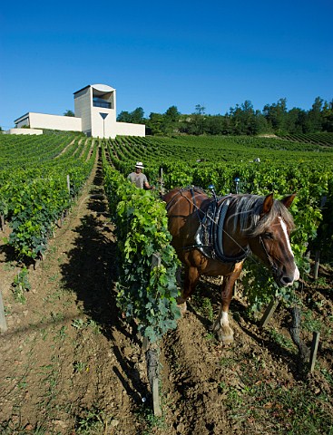 Harrowing the soil in vineyard below the winery of Chteau Faugres StEtiennedeLisse near Saintmilion Gironde France Stmilion  Bordeaux
