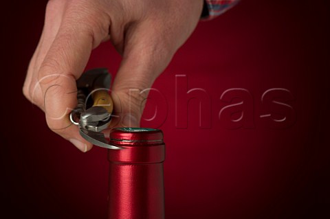 Removing the capsule of a wine bottle with a Laguiole corkscrew
