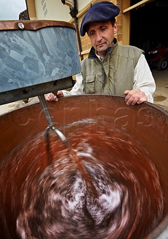 Bruno Ciofi watches the vortex in his dynamiseur  the biodynamic method for mixing a spray preparation  Domaine de la Pinte Arbois Jura France