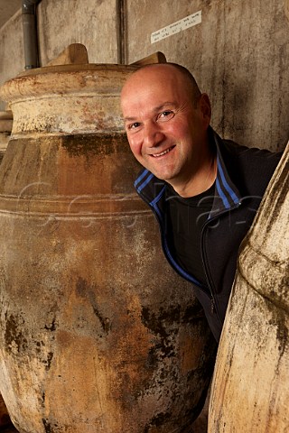 Stphane Tissot with amphorae used for ageing Savagnin and sometimes Trousseau in winery of Domaine Andr et Mireille Tissot MontignylsArsures Jura France  Arbois