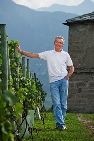 Costantino Charrre in his Les Crtes vineyard with Coteau la Tour behind Aymavilles Valle dAosta Italy  Valle dAosta