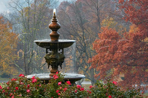 Fountain and autumnal trees in the gardens of the Mark Addy Inn Nellysford Virginia USA