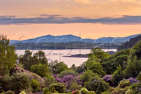 Loch Linnhe and island of Lismore viewed over gardens of Druimneil House at dusk Port Appin Argyllshire Scotland