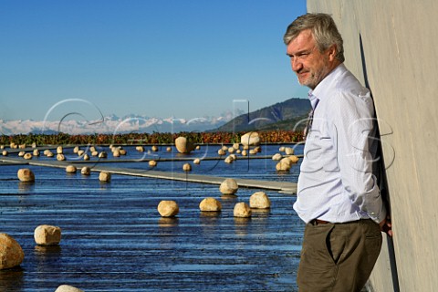 Patrick Valette winemaker by the water and rock art installation at the winery of Via Vik Millahue Chile Millahue Valley