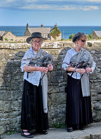 Two women playing Northumbrian smallpipes  Cresswell Northumberland England