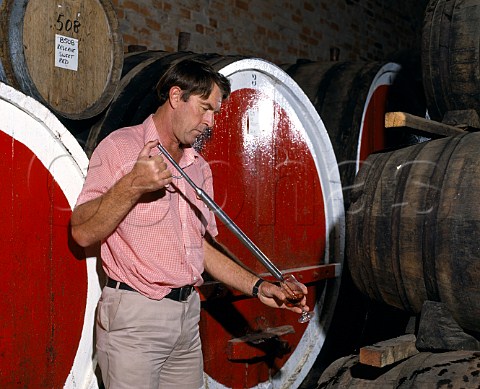 Colin Campbell checks the progress of his Tawny Port   ageing in barrel  Campbells winery Rutherglen   Victoria Australia     Rutherglen