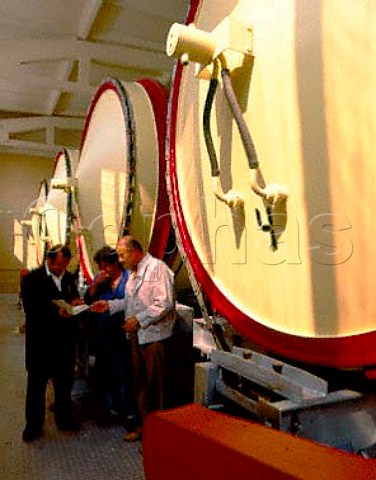 Rossen Afusov r the director of Vini Sliven   winery the largest in Bulgaria discusses harvest   details in front of newly insatalled rotary   fermenters at his Blatetz winery  SubBalkan region