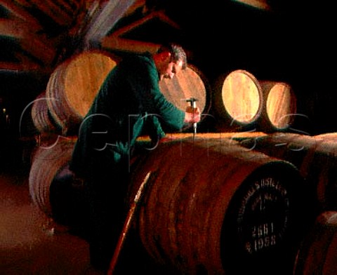 Removing bung from a barrel of malt whiskey   exsherry butt in warehouse of the Old Bushmills   Distillery Bushmills CoAntrim Northern Ireland