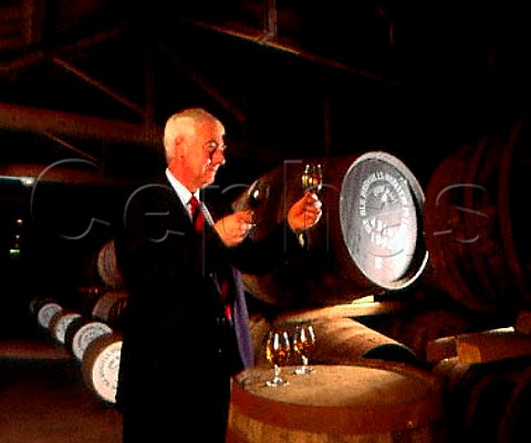 Frank McHardy Master Distiller checks on progress   of his whiskey maturing in cask in the atmospheric   No7 warehouse of the Old Bushmills Distillery   Bushmills CoAntrim Northern Ireland