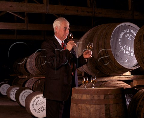 Frank McHardy Master Distiller checks on progress   of his whiskey maturing in cask in the atmospheric   No7 warehouse of the Old Bushmills Distillery   Bushmills CoAntrim Northern Ireland