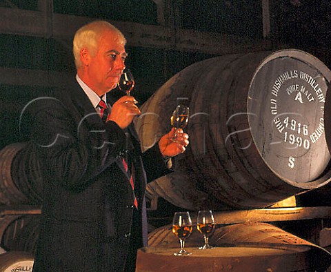 Frank McHardy Master Distiller checks on progress   of his whiskey maturing in cask in the atmospheric   No7 warehouse of the Old Bushmills Distillery   Bushmills CoAntrim Northern Ireland