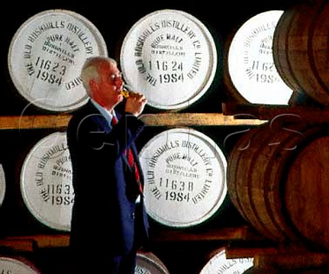 Frank McHardy Master Distiller checks on progress   of his whiskey maturing in cask  Old Bushmills   Distillery Bushmills CoAntrim Northern Ireland