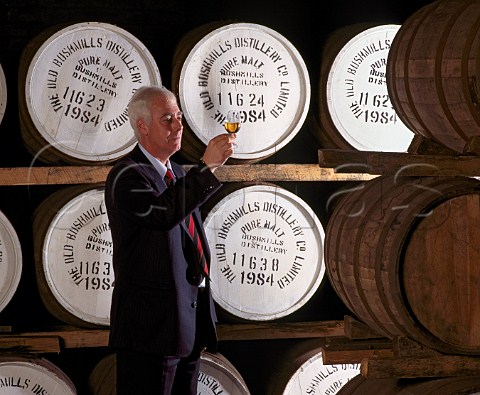Frank McHardy Master Distiller checks on progress   of his whiskey maturing in cask  Old Bushmills   Distillery Bushmills CoAntrim Northern Ireland