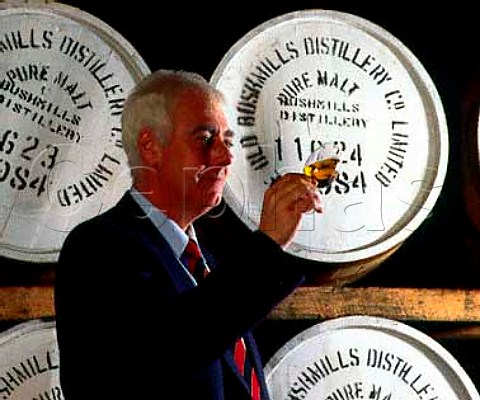 Frank McHardy Master Distiller checks on progress   of his whiskey maturing in cask  Old Bushmills   Distillery Bushmills CoAntrim Northern Ireland