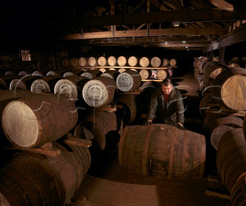 Rolling a cask of whiskey ex sherry butt through the atmospheric No7 warehouse of the Old Bushmills Distillery Bushmills Co Antrim Northern Ireland