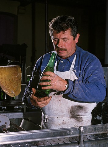 Sniffing bottle of champagne after dgorgement to ensure it is clean Champagne Bollinger Ay Marne France