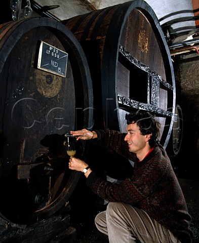 Etienne Hugel taking sample of fermenting must  from cask Behind him is the StCatherine Cask the   oldest cask in the world 1715 still in continuous   use   Hugel et Fils Riquewihr HautRhin France     Alsace