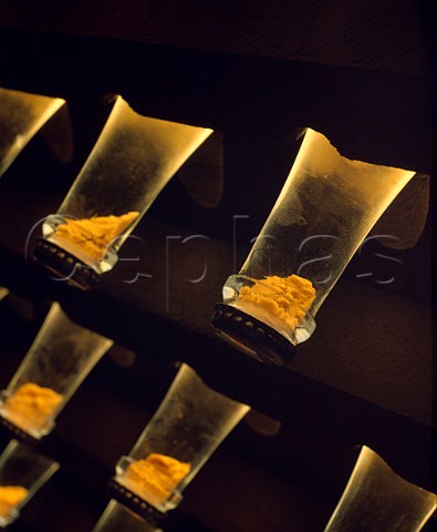 Necks of bottles of Cristal champagne in pupitre in the cellars of Louis Roederer  the sediment can be seen collected in the caps Reims Marne France