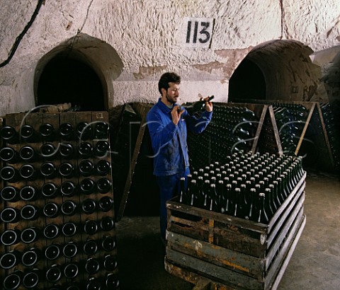 Shaking bottles of La Grande Dame before putting them in pupitres to undergo the remuage in the cellars of Veuve ClicquotPonsardin in the old  GalloRoman chalk quarries of Reims   Marne France  Champagne