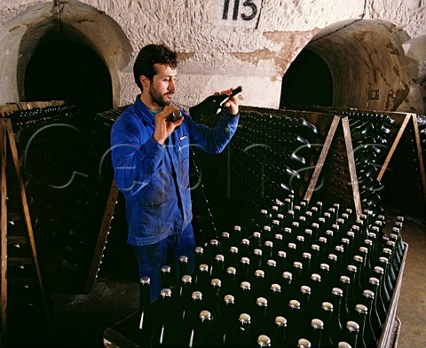 Shaking bottles of La Grande Dame before putting in pupitres to undergo the remuage Champagne Veuve ClicquotPonsardin Reims Marne France