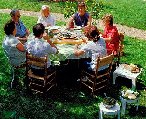 Three generations of a  French family at lunch in   garden