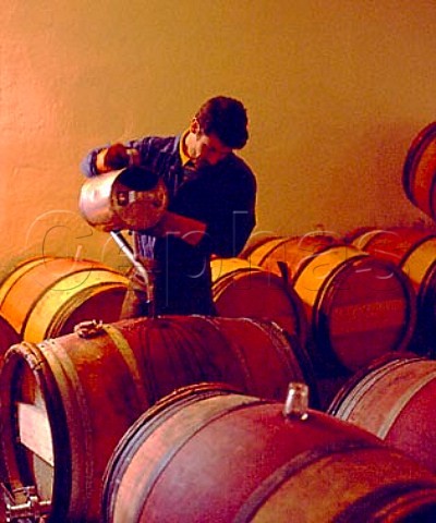 Toppingup barrels after racking in the 1styear   chai of Chteau MoutonRothschild  Pauillac Gironde France   Mdoc  Bordeaux