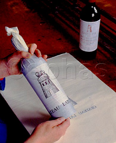 The finishing touch to a bottle of 1949 Chteau   Latour tissue wrapping by hand with the archway   carefully placed above the vintage date on the   label Pauillac Gironde France  Mdoc  Bordeaux