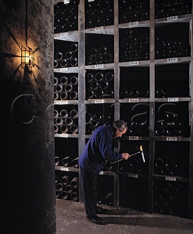 The matre de chai examining Jeroboams of 1983 in the vintage bottle cellar of Chteau Latour Pauillac Gironde France Mdoc  Bordeaux