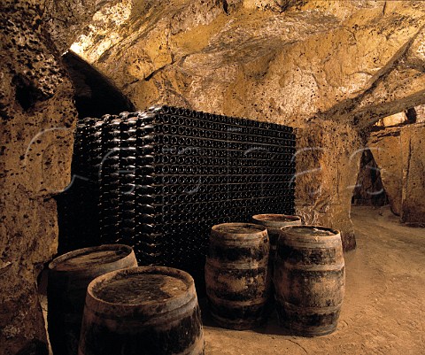 Bottles of wine maturing in cave which has been hewn out of the soft tuffeau subsoil   Chteau de la Grille Chinon IndreetLoire France