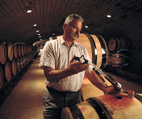 Robert JayerGilles taking sample from barrel in his   cellars at MagnylesVillers Cte dOr France