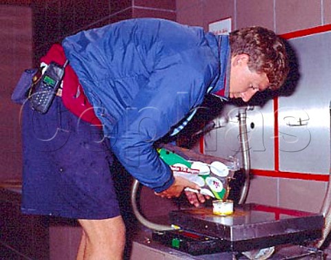 Winemaker weighing out tannin to add to a tank of   fermenting Merlot at the Union de Producteurs de   Rauzan Gironde France     Bordeaux  EntreDeuxMers